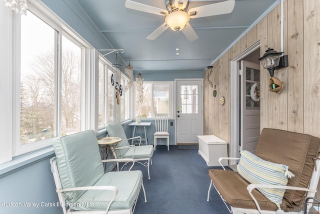 sunroom / solarium featuring ceiling fan