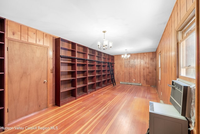 660-668 N Chodikee Lake Rd, Highland, NY 12528 - unfurnished room featuring a chandelier, a baseboard radiator, light wood-style flooring, and wood walls