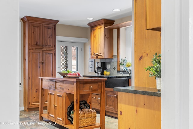 660-668 N Chodikee Lake Rd, Highland, NY 12528 - kitchen with dark countertops, recessed lighting, decorative backsplash, and a sink