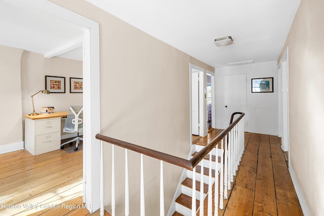 660-668 N Chodikee Lake Rd, Highland, NY 12528 - hall with light wood-style flooring, an upstairs landing, a desk, and baseboards