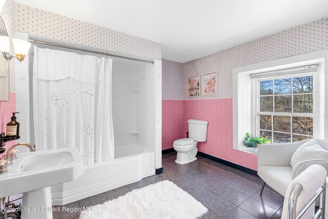660-668 N Chodikee Lake Rd, Highland, NY 12528 - full bath featuring tile walls, wallpapered walls, a wainscoted wall, granite floors, and shower / bath combo
