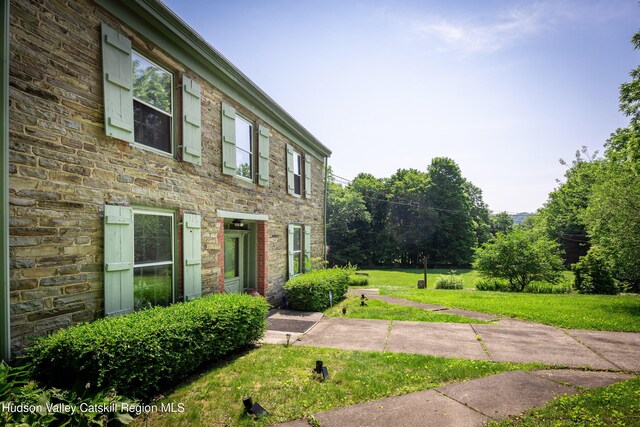 660-668 N Chodikee Lake Rd, Highland, NY 12528 - view of front of house featuring a front lawn and stone siding