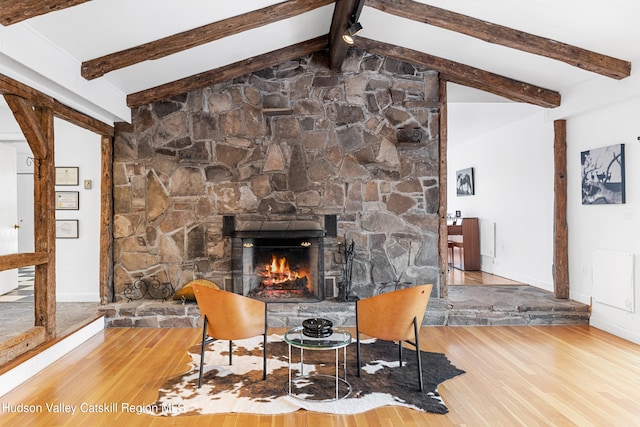660-668 N Chodikee Lake Rd, Highland, NY 12528 - living room with wood finished floors, a stone fireplace, and baseboards