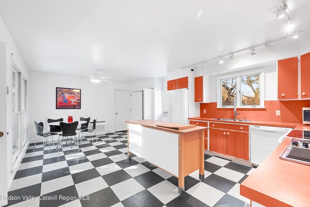 660-668 N Chodikee Lake Rd, Highland, NY 12528 - kitchen featuring white appliances, a sink, dark flooring, track lighting, and ceiling fan