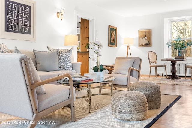 660-668 N Chodikee Lake Rd, Highland, NY 12528 - sitting room with radiator heating unit, wood finished floors, and baseboards