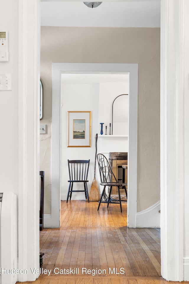 660-668 N Chodikee Lake Rd, Highland, NY 12528 - hallway featuring wood-type flooring and radiator