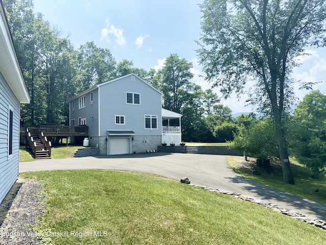 208 Paul Saxe Rd, Catskill, NY 12414 - view of side of home featuring driveway, stairway, a yard, an attached garage, and a wooden deck