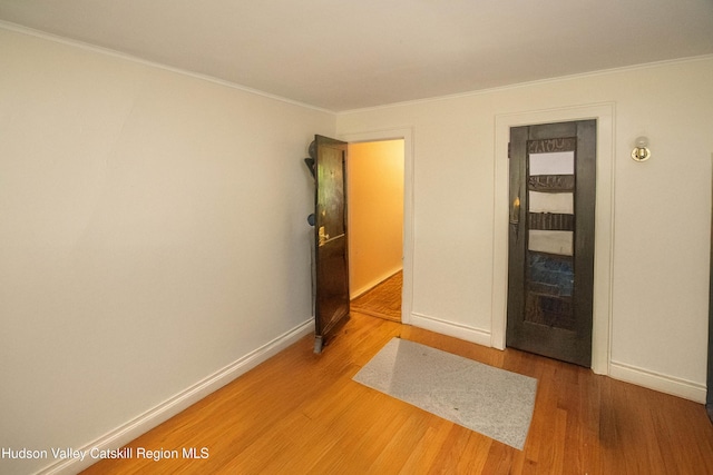 38 Plattekill Ave, New Paltz, NY 12561 - unfurnished bedroom with wood finished floors and crown molding