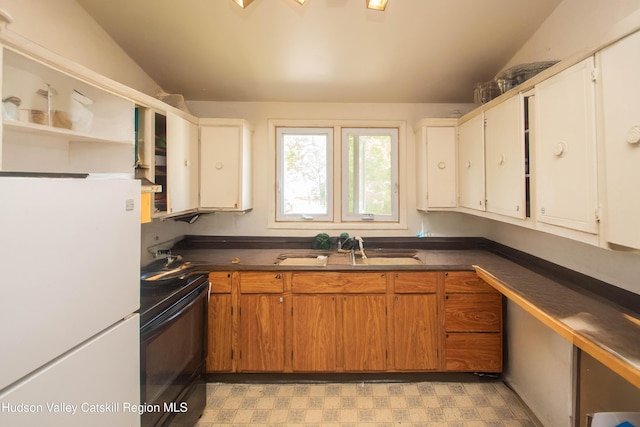 38 Plattekill Ave, New Paltz, NY 12561 - kitchen with black range with electric cooktop, freestanding refrigerator, light floors, dark countertops, and lofted ceiling