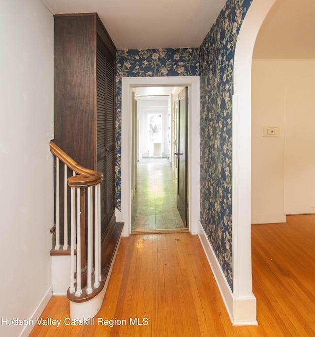 38 Plattekill Ave, New Paltz, NY 12561 - corridor featuring arched walkways, hardwood / wood-style floors, and wallpapered walls