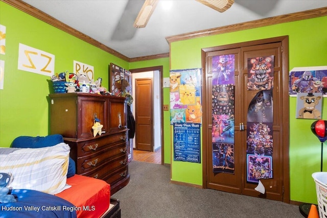 carpeted bedroom featuring ceiling fan and ornamental molding