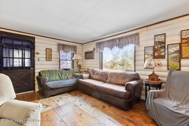 living room with hardwood / wood-style floors and log walls