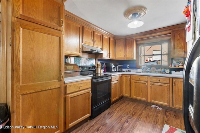 kitchen with wood-type flooring and black / electric stove