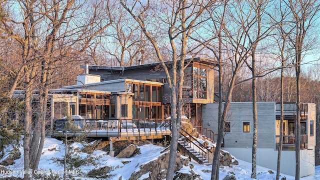 view of front of home featuring a wooden deck and stairway