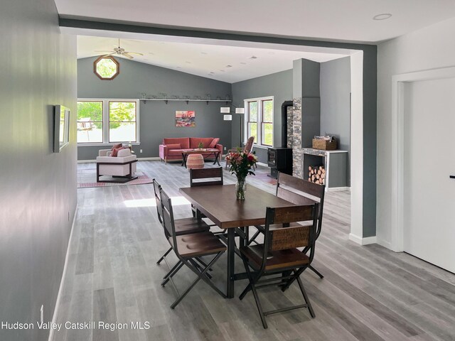 4947 Rte 32, Catskill, NY 12414 - dining area with wood finished floors, vaulted ceiling, plenty of natural light, and a wood stove