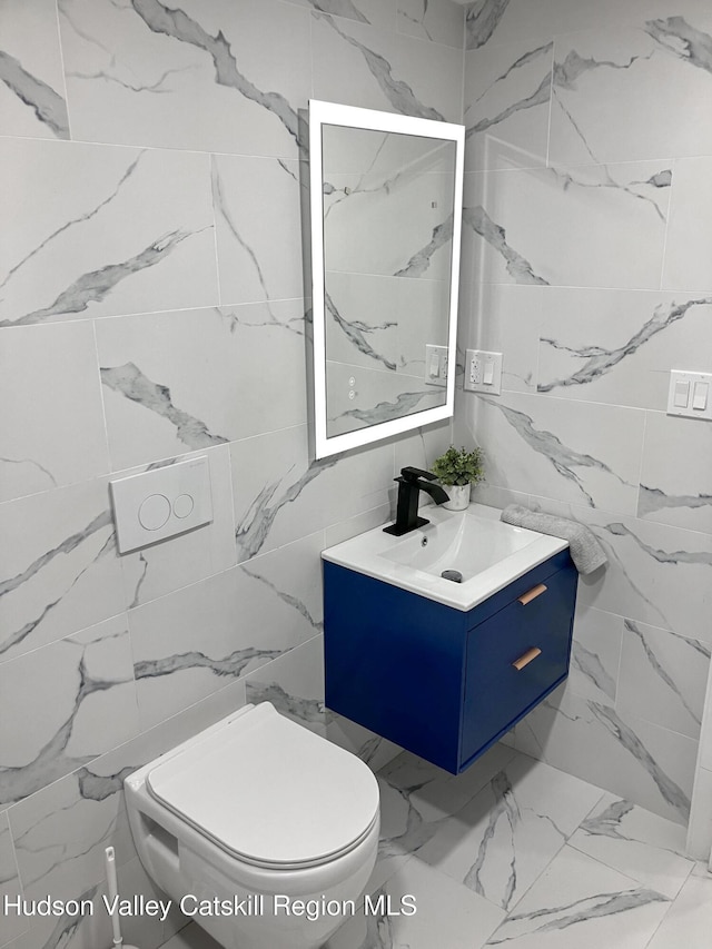 4947 Rte 32, Catskill, NY 12414 - half bathroom with vanity, marble look tiles, tile walls, and toilet