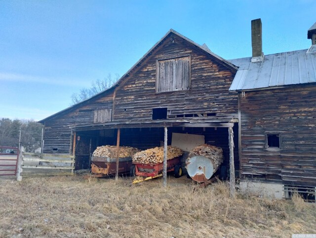 1644 Rte 9, Stuyvesant, NY 12173 - view of side of home with a barn, an outbuilding, fence, a chimney, and metal roof