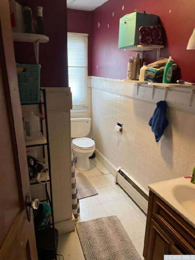 1644 Rte 9, Stuyvesant, NY 12173 - bathroom with baseboard heating, tile walls, toilet, a wainscoted wall, and vanity