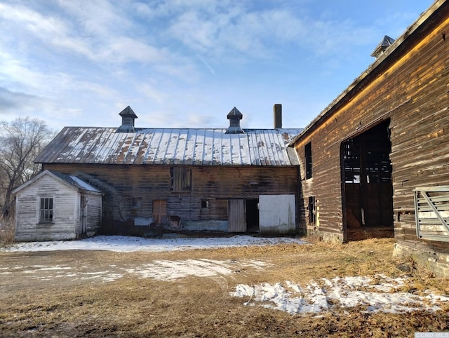 1644 Rte 9, Stuyvesant, NY 12173 - snow covered rear of property with a standing seam roof, an outbuilding, metal roof, and a barn