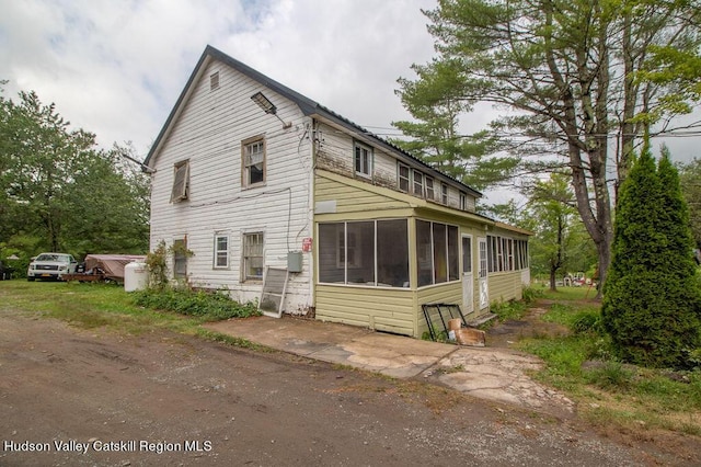 view of side of property with a sunroom