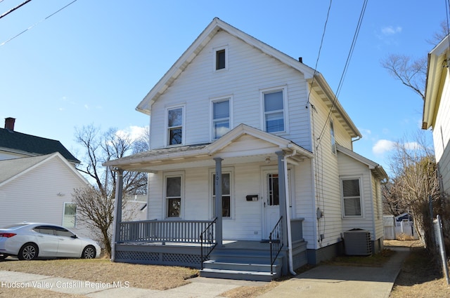 view of front of house featuring cooling unit and covered porch