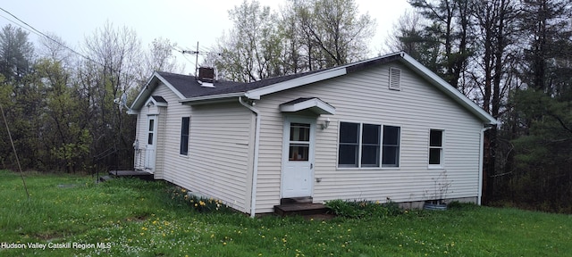 16 Lake Rd, Rensselaerville, NY 12147 - view of home's exterior with a chimney, a yard, entry steps, and a shingled roof
