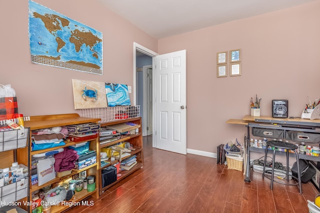 interior space featuring dark wood-style flooring and baseboards