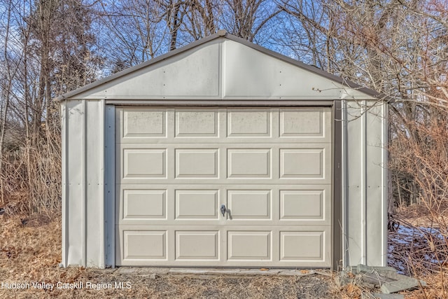 detached garage featuring driveway