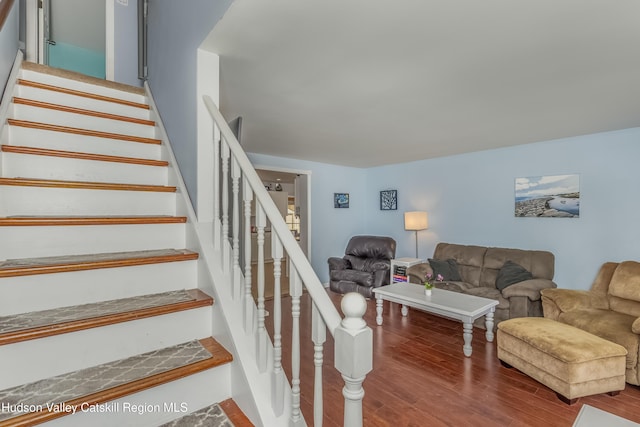 stairs featuring wood finished floors