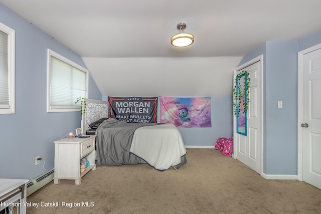 bedroom with a baseboard heating unit, lofted ceiling, light colored carpet, and baseboards