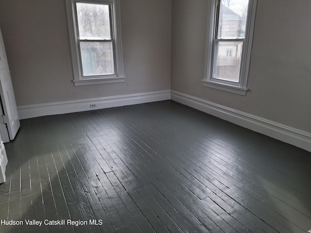 spare room featuring dark wood-type flooring