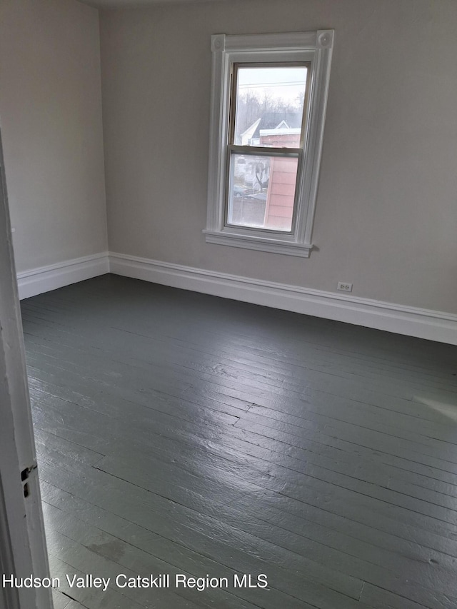 empty room with dark hardwood / wood-style flooring