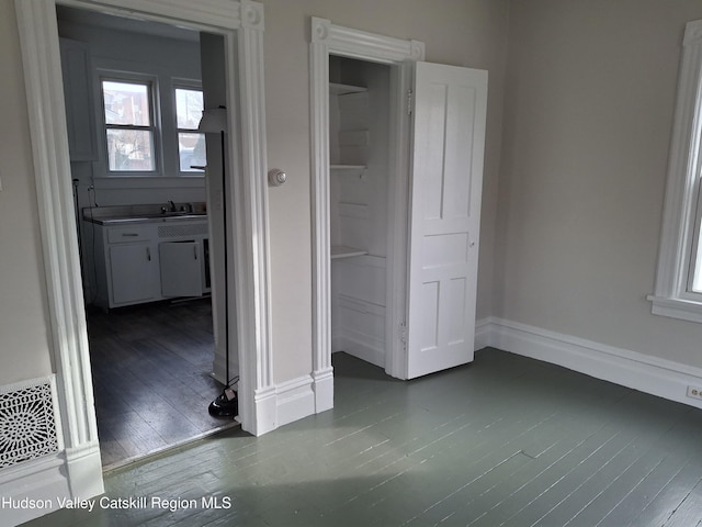 unfurnished bedroom with dark wood-type flooring