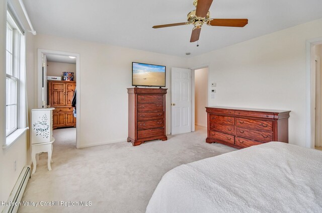 825 County Route 403, Greenville, NY 12083 - carpeted bedroom featuring a baseboard heating unit, multiple windows, baseboards, and ceiling fan