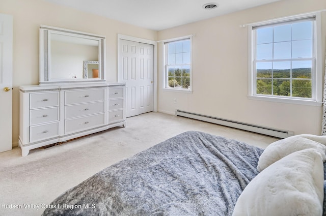 825 County Route 403, Greenville, NY 12083 - carpeted bedroom with a baseboard radiator, multiple windows, and a closet