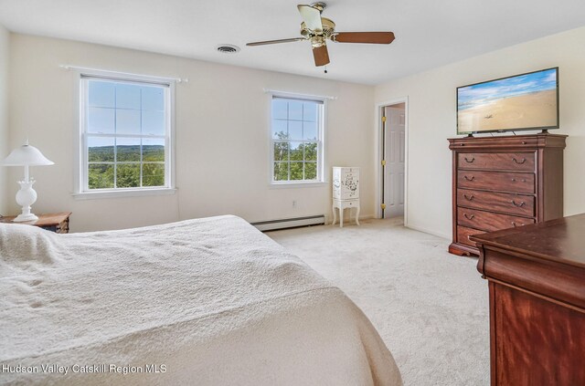 825 County Route 403, Greenville, NY 12083 - bedroom featuring baseboard heating, light colored carpet, a ceiling fan, and baseboards