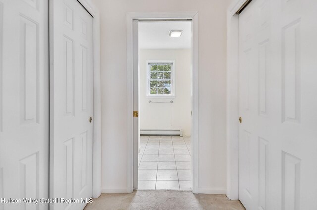 825 County Route 403, Greenville, NY 12083 - hall featuring a baseboard radiator, light carpet, baseboards, and light tile patterned floors