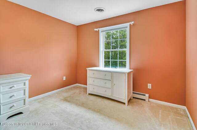 825 County Route 403, Greenville, NY 12083 - unfurnished bedroom featuring a baseboard heating unit, light colored carpet, and baseboards