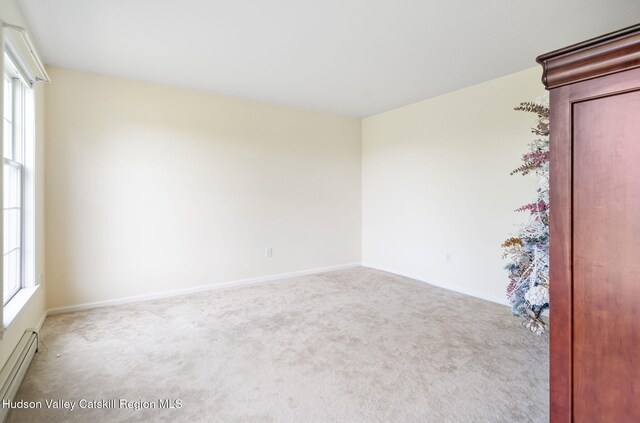 825 County Route 403, Greenville, NY 12083 - carpeted spare room featuring baseboard heating, healthy amount of natural light, and baseboards