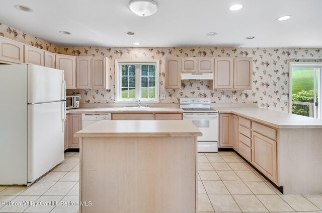 825 County Route 403, Greenville, NY 12083 - kitchen featuring white appliances, under cabinet range hood, a sink, light brown cabinetry, and a peninsula
