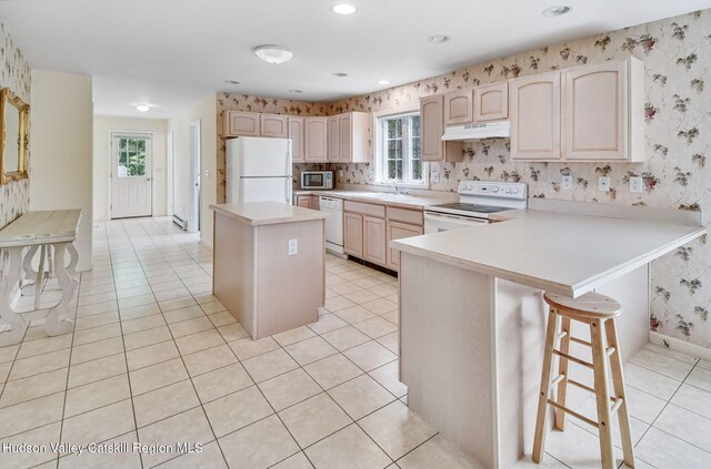 825 County Route 403, Greenville, NY 12083 - kitchen with white appliances, under cabinet range hood, wallpapered walls, a sink, and a peninsula