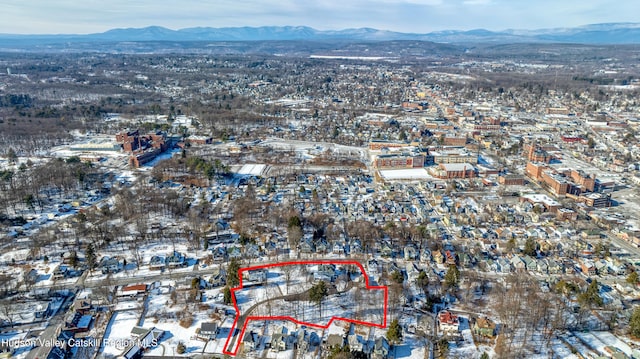 snowy aerial view with a mountain view