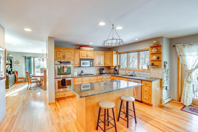 220 Botti Dr, Hunter, NY 12442 - kitchen with a chandelier, appliances with stainless steel finishes, baseboard heating, a breakfast bar area, and a kitchen island