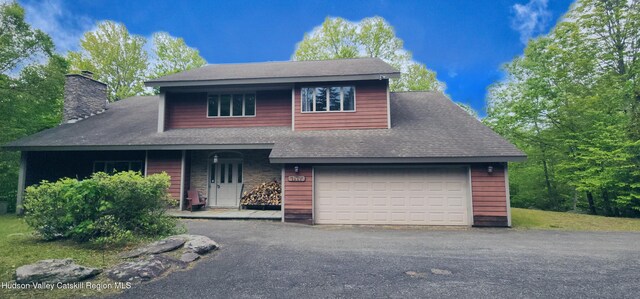 220 Botti Dr, Hunter, NY 12442 - view of front facade featuring a chimney, a garage, roof with shingles, and asphalt driveway