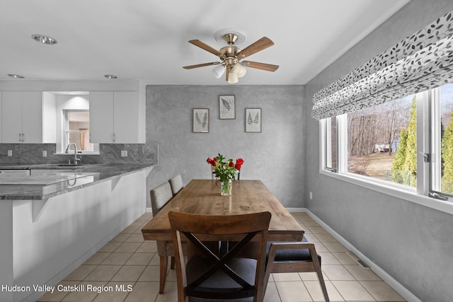 dining room featuring light tile patterned floors and ceiling fan