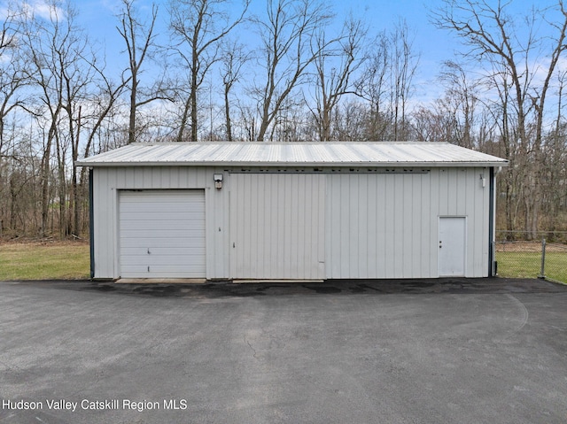 detached garage featuring fence