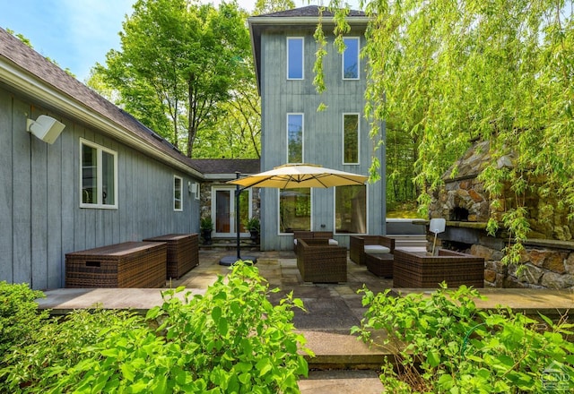 rear view of house with outdoor lounge area and a patio