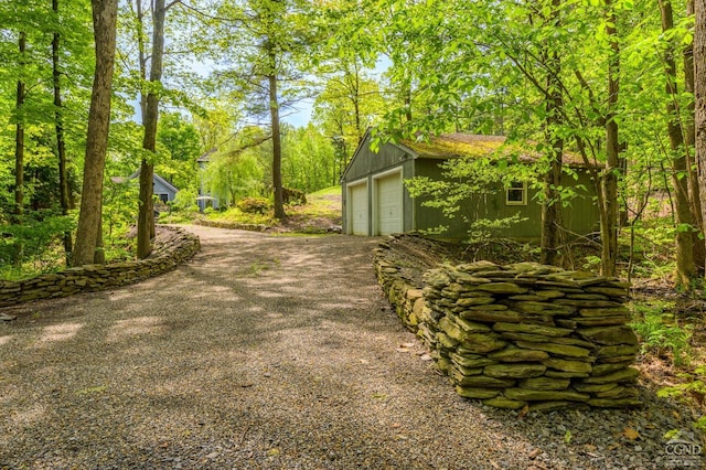 view of yard with an outbuilding and a detached garage
