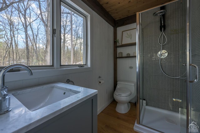 full bathroom with wood finished floors, a stall shower, wooden ceiling, toilet, and vanity