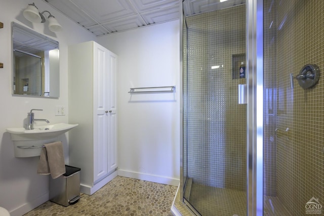 bathroom with a stall shower and baseboards
